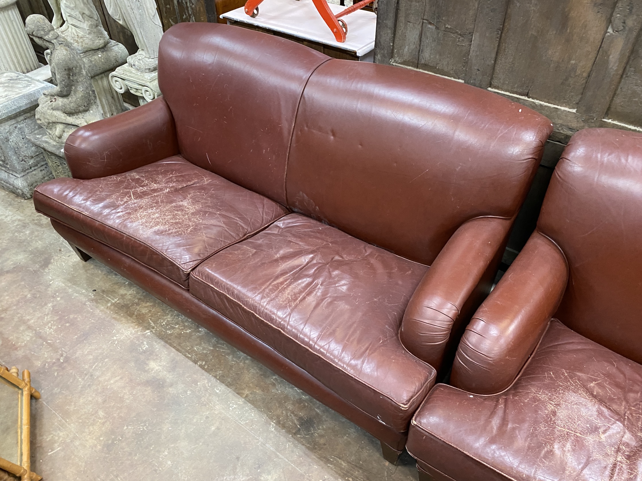 A pair of Howard style burgundy leather sofa's, width 170cm, depth 90cm, height 84cm